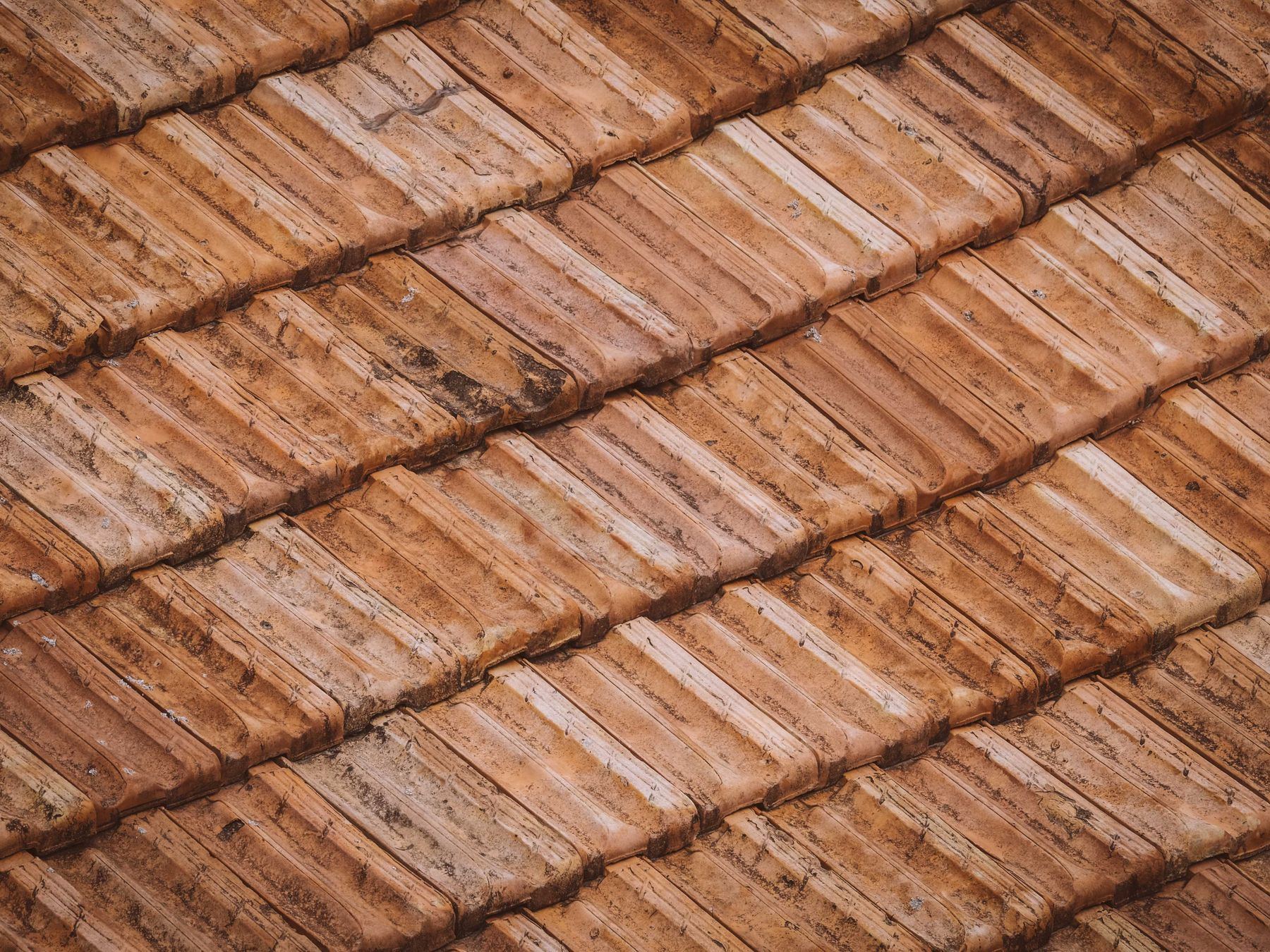 Close-up texture of weathered clay roof tiles.